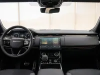 The luxurious black interior of the 2023 Land Rover Range Rover Sport, featuring its modern dashboard, steering wheel, and central touchscreen in Lausanne.