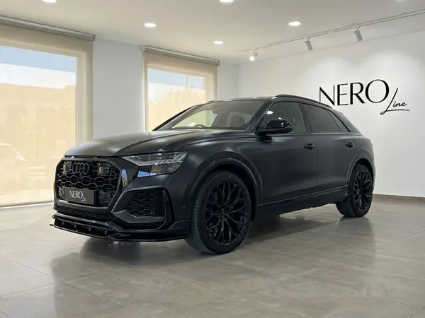 A matte black Audi SQ8 RS Body, 2020 model, displayed in a showroom in Alicante, Spain, showcasing its aggressive front design.