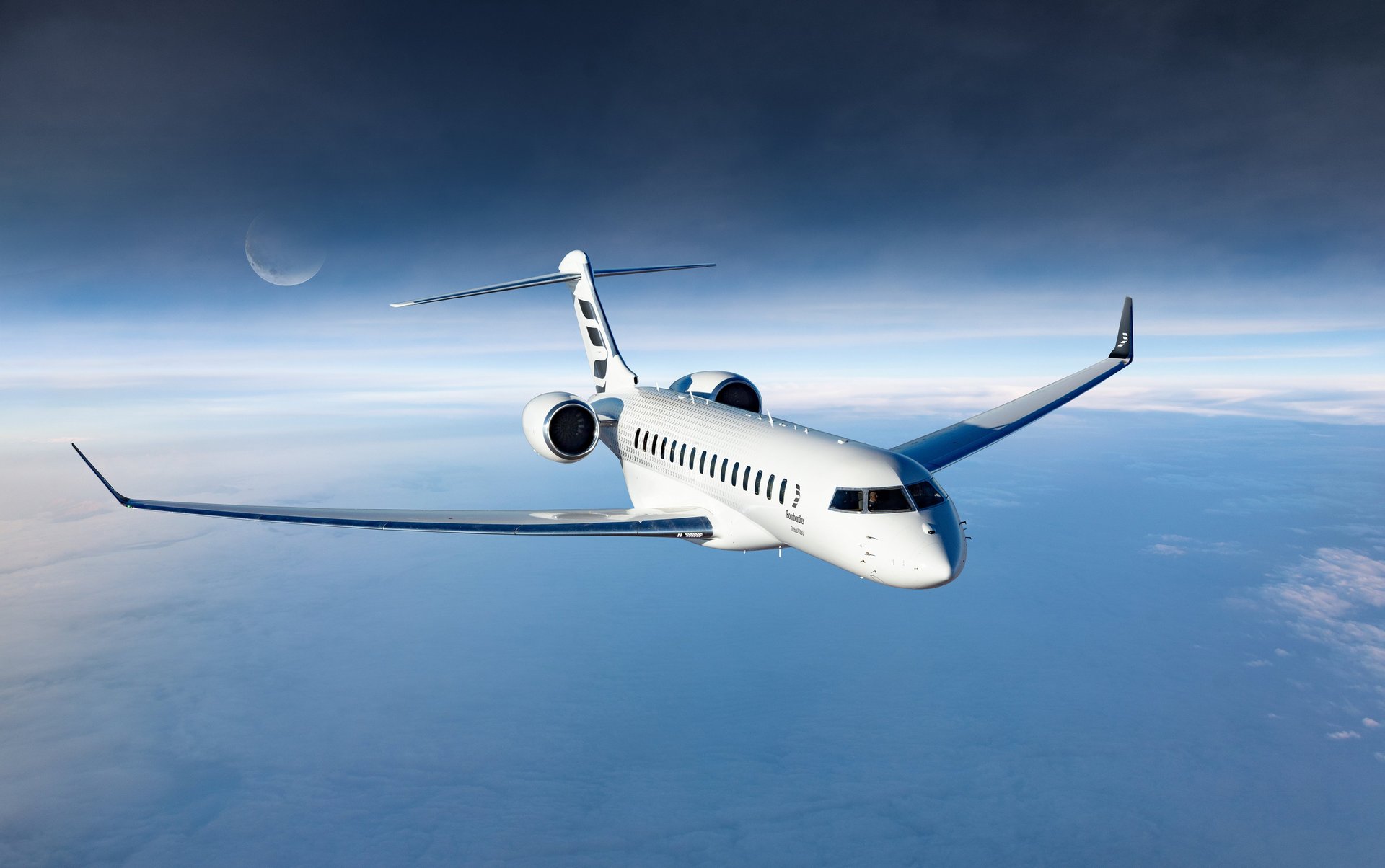 The Bombardier Global 8000 private jet flies high above the clouds with a crescent moon in the dark sky, available for charter from Marbella.