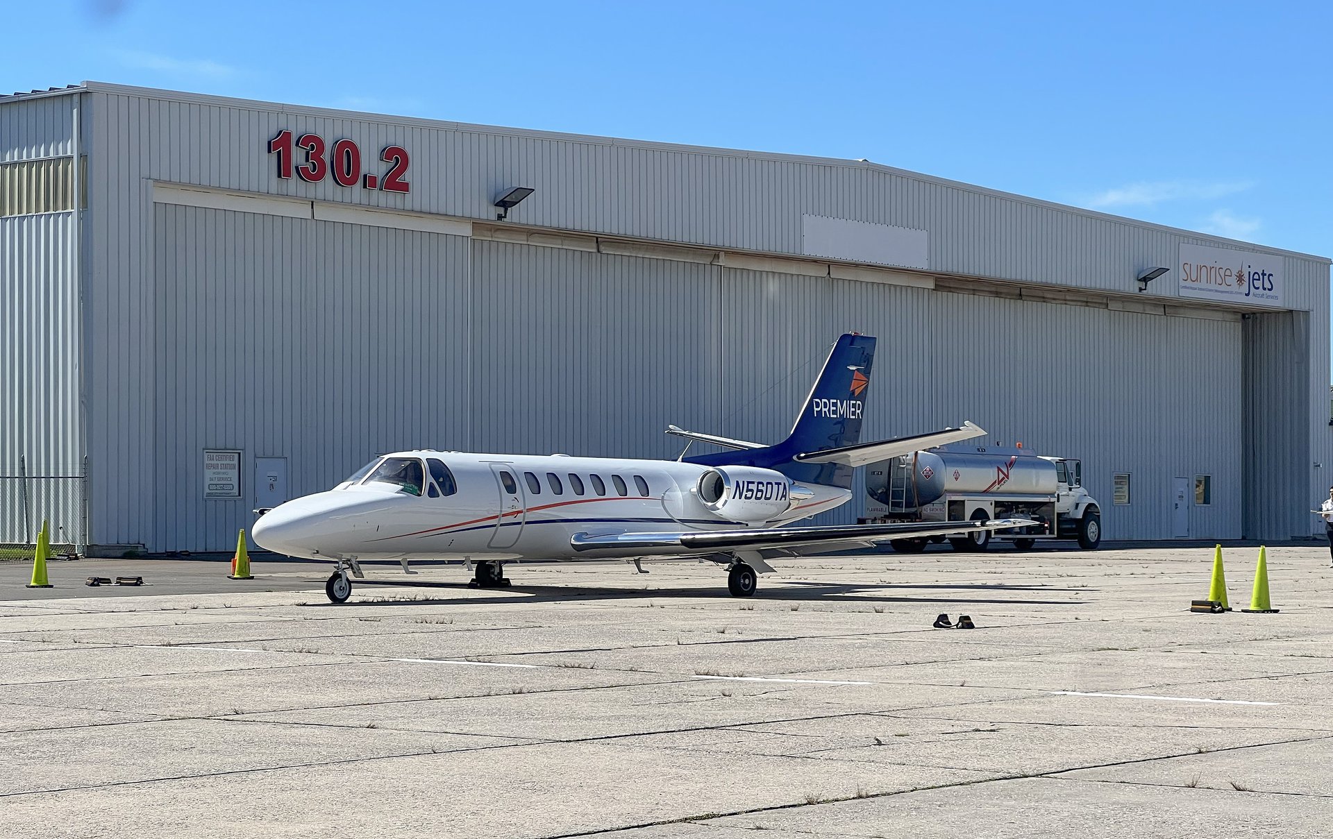 Cessna Citation Ultra — Parked on tarmac, Malaga Cessna Citation Ultra light jet parked on the tarmac in Malaga, with a fuel truck and hangar in the background.
