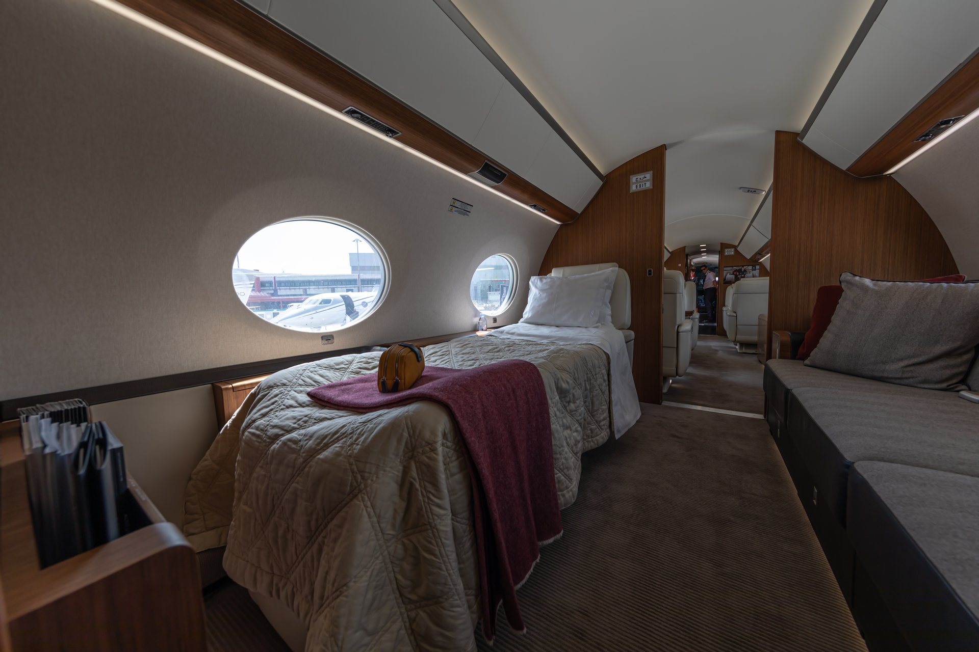 Gulfstream G650 — Luxurious cabin sleeping berth The luxurious Gulfstream G650 cabin features a comfortable sleeping berth and lounge area, with another jet visible outside in Marbella.