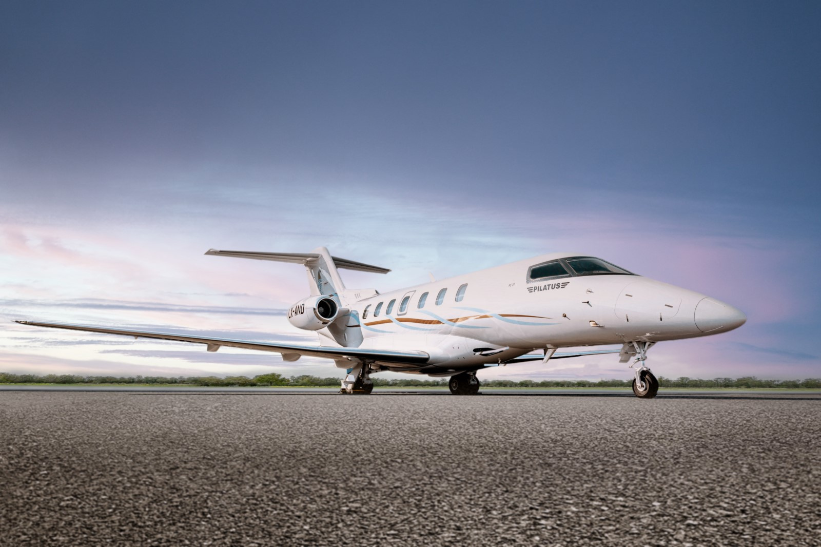 Pilatus PC-24 — Ready for departure The white Pilatus PC-24 light jet stands on a runway at Malaga, ready for departure under a twilight sky.