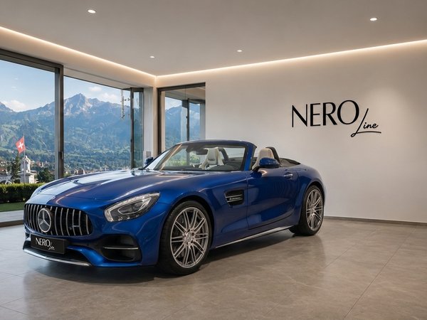 Mercedes-AMG GT Roadster — Luxury showroom in Zurich A blue Mercedes-AMG GT Roadster convertible is parked in a luxury showroom, with panoramic views of the Zurich mountains.
