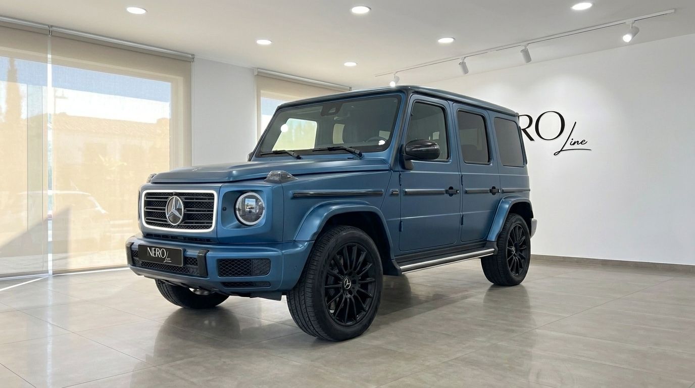 The matte dark blue Mercedes-Benz G 580 EQ is shown from a front three-quarter angle in a showroom in Mallorca.