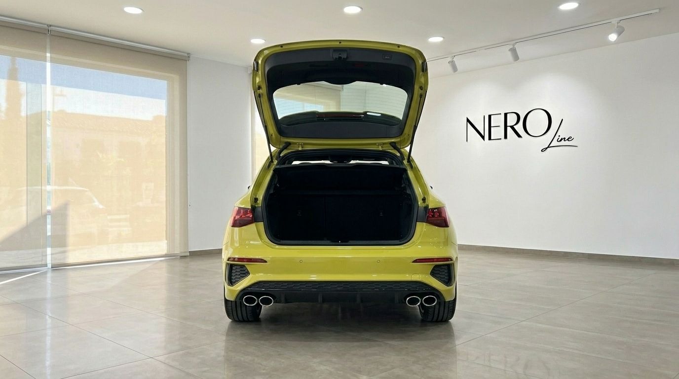 The rear view of a gloss Python Yellow Audi S3 with its trunk open, showcasing cargo space in Alicante.