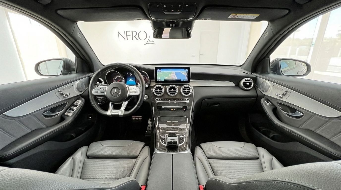 The luxurious interior of the Mercedes-Benz GLC 63 S AMG, showcasing its dashboard, steering wheel, and front seats in Alicante.