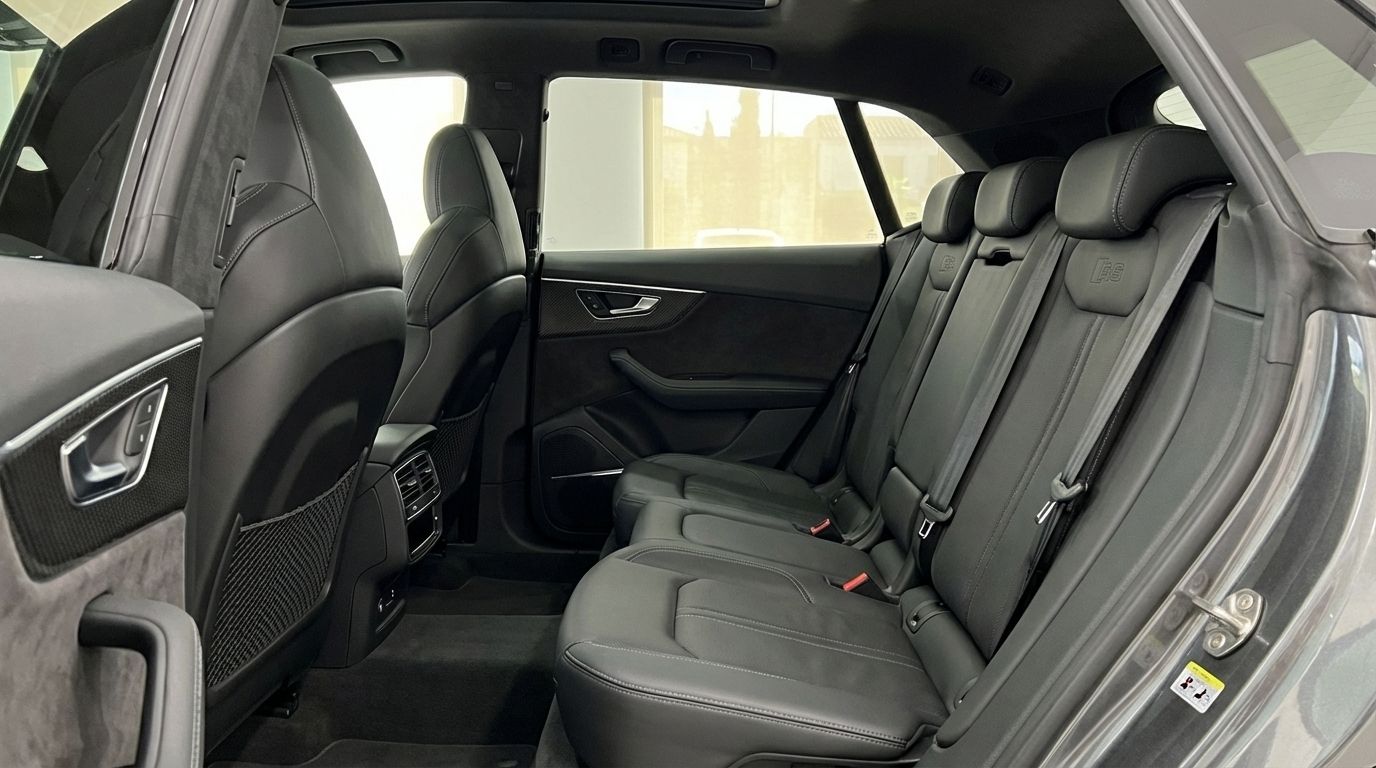 The spacious black leather rear seats and door panel of the Audi RS Q8, showcasing its luxurious interior in Alicante.