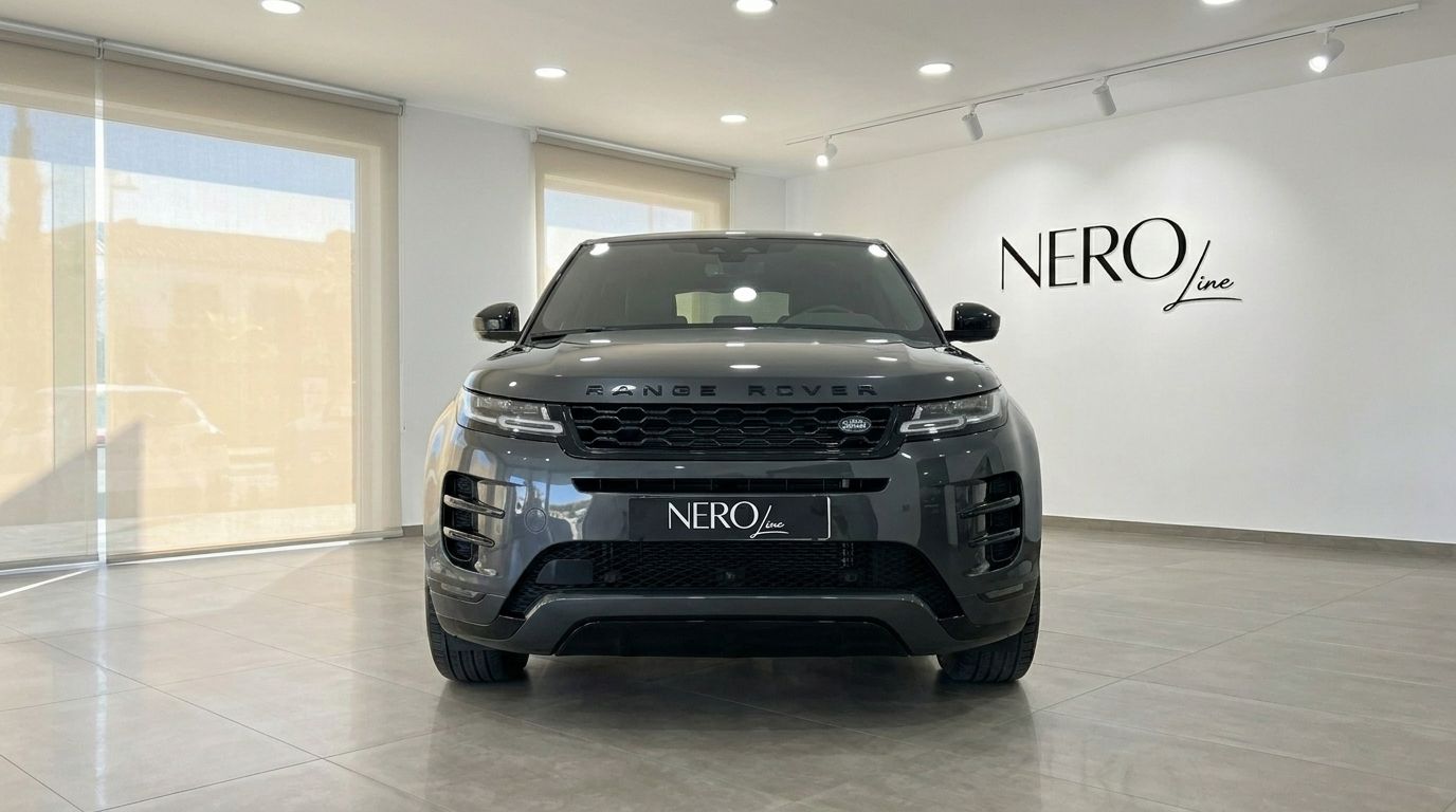 The metallic black Land Rover Range Rover Evoque R-Dynamic (1st) is showcased from the front in a bright Alicante showroom.