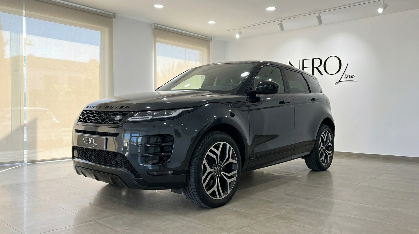 Land Rover Range Rover Evoque R-Dynamic — Showroom A dark grey Land Rover Range Rover Evoque R-Dynamic (1st) is showcased from a front three-quarter angle inside a modern showroom in Alicante.