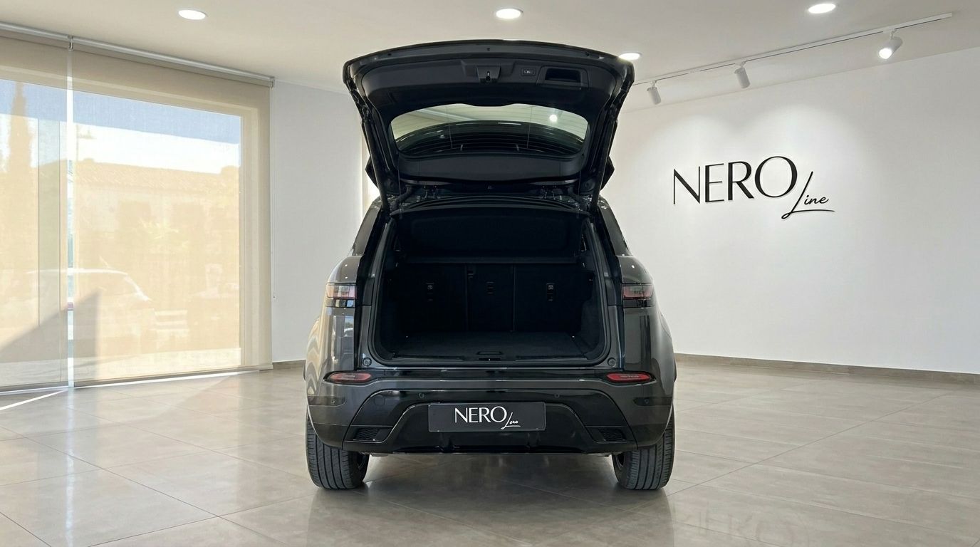 The rear view of a black Land Rover Range Rover Evoque R-Dynamic with its tailgate open, showcasing the trunk space in Alicante.
