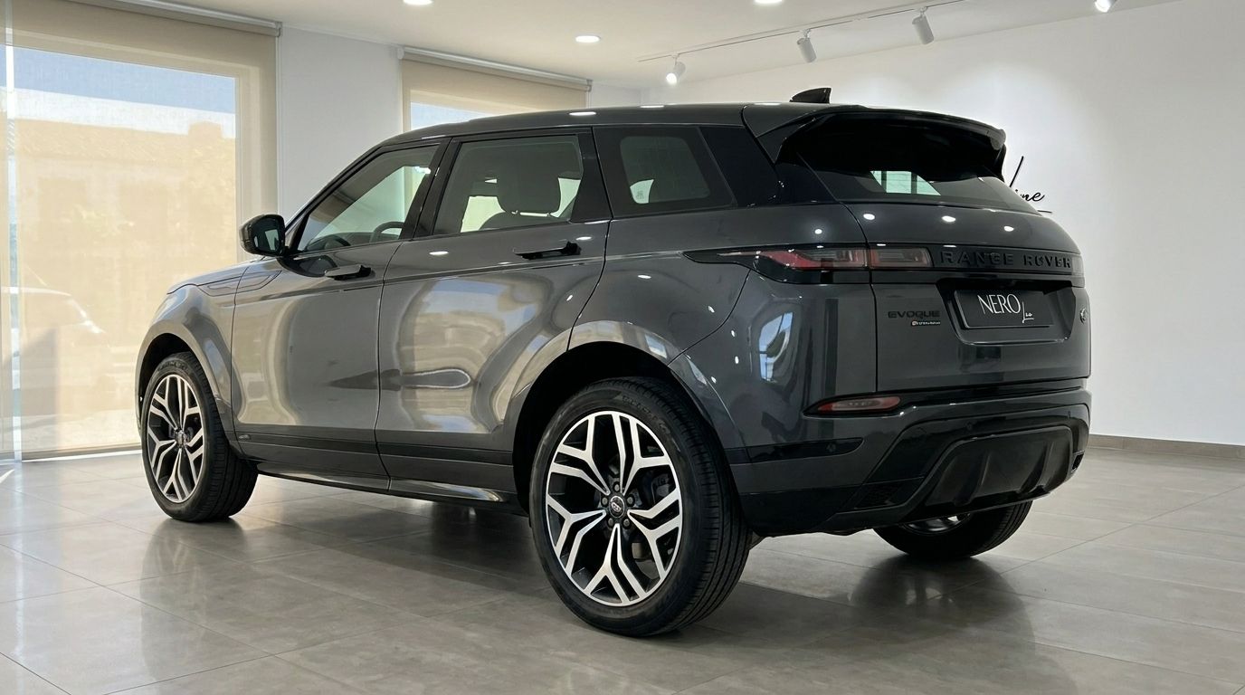 The dark grey 2022 Land Rover Range Rover Evoque R-Dynamic is shown from a rear three-quarter angle in Alicante.