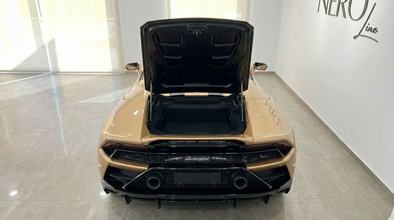 The golden beige Lamborghini Huracan Evo Spyder from the rear, showcasing its open front trunk and sleek design in Ibiza.