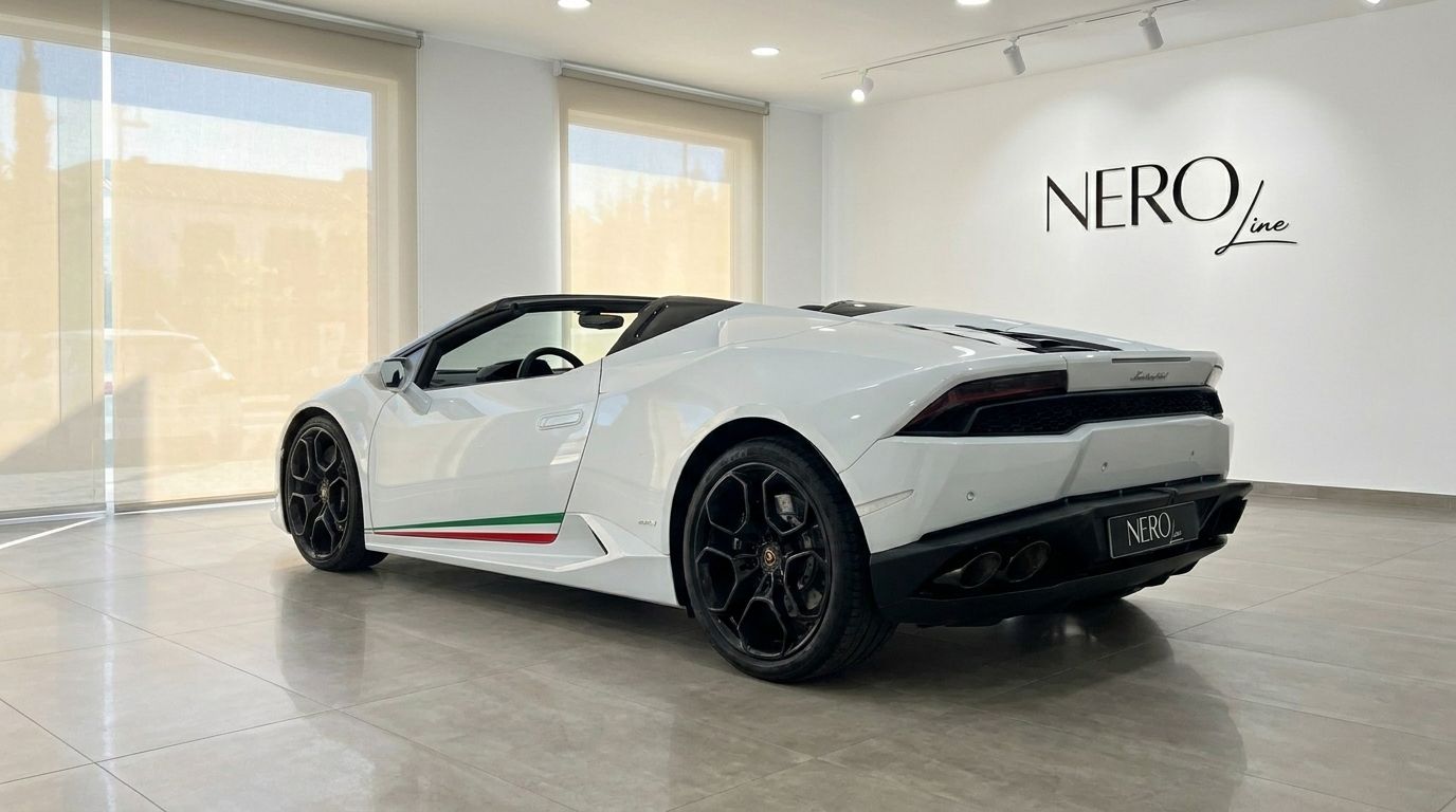 White Lamborghini Huracan Spyder LP610-4, seen from the rear three-quarter angle, parked inside a showroom in Alicante.