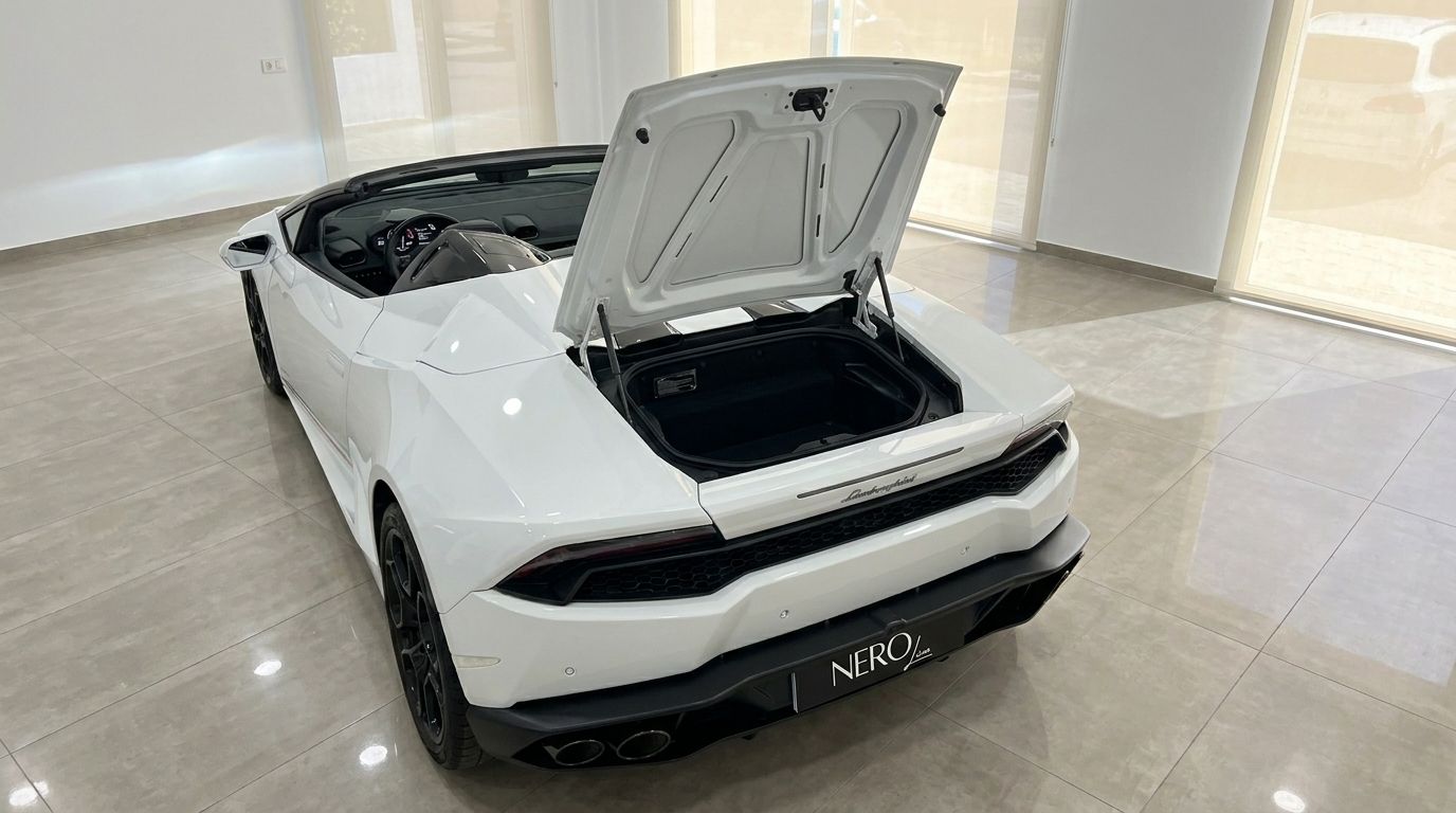 White Lamborghini Huracan Spyder LP610-4 with its front trunk open, viewed from the rear-three-quarter angle in Alicante.