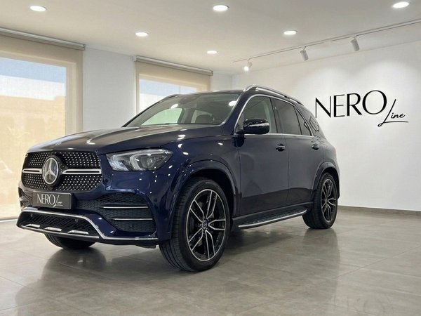 Mercedes-Benz GLE 350de — SUV de lujo en Alicante SUV Mercedes-Benz GLE 350de 4MATIC AMG azul oscuro en vista tres cuartos frontal, aparcado en un concesionario en Alicante.