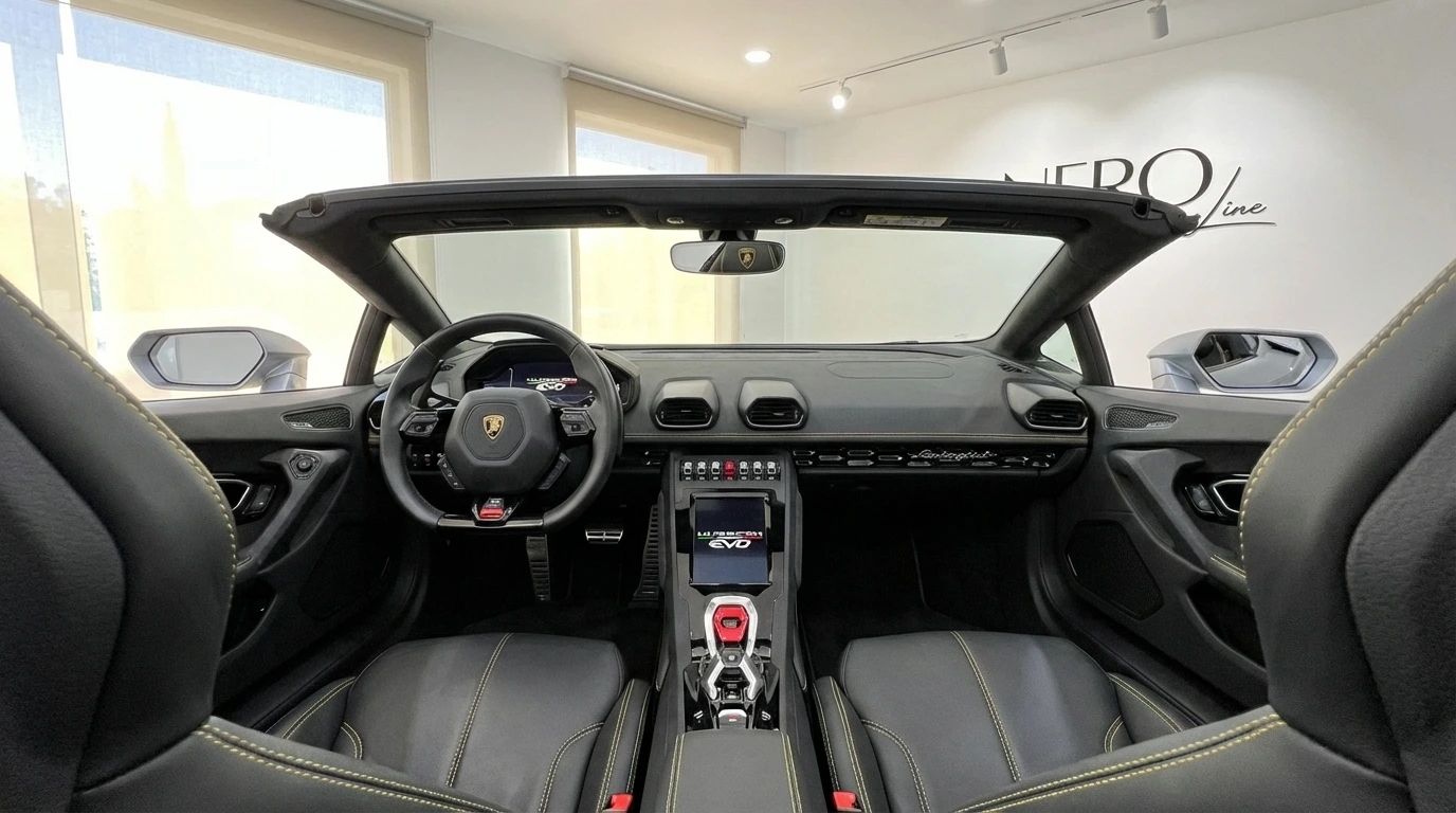 The luxurious interior cockpit of the Lamborghini Huracan Evo Spyder 60th Anniversary, featuring black leather seats with yellow stitching and a central touchscreen, in Ibiza.
