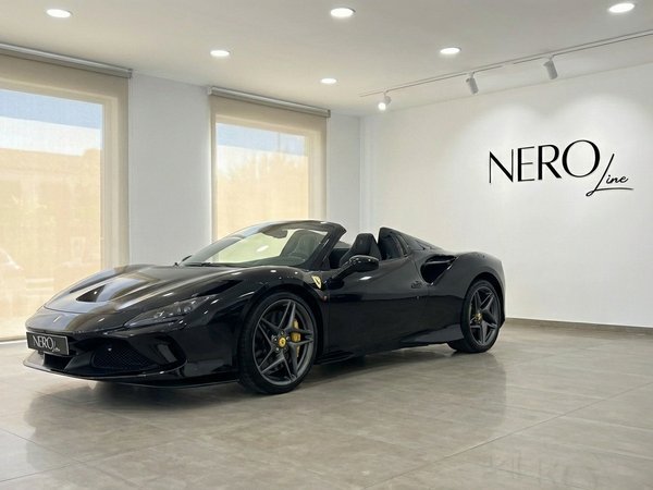 Ferrari F8 Spider — Luxury Convertible Rental Ibiza A black Ferrari F8 Spider convertible is parked in a bright showroom with the NEROline logo on the wall, available in Ibiza.