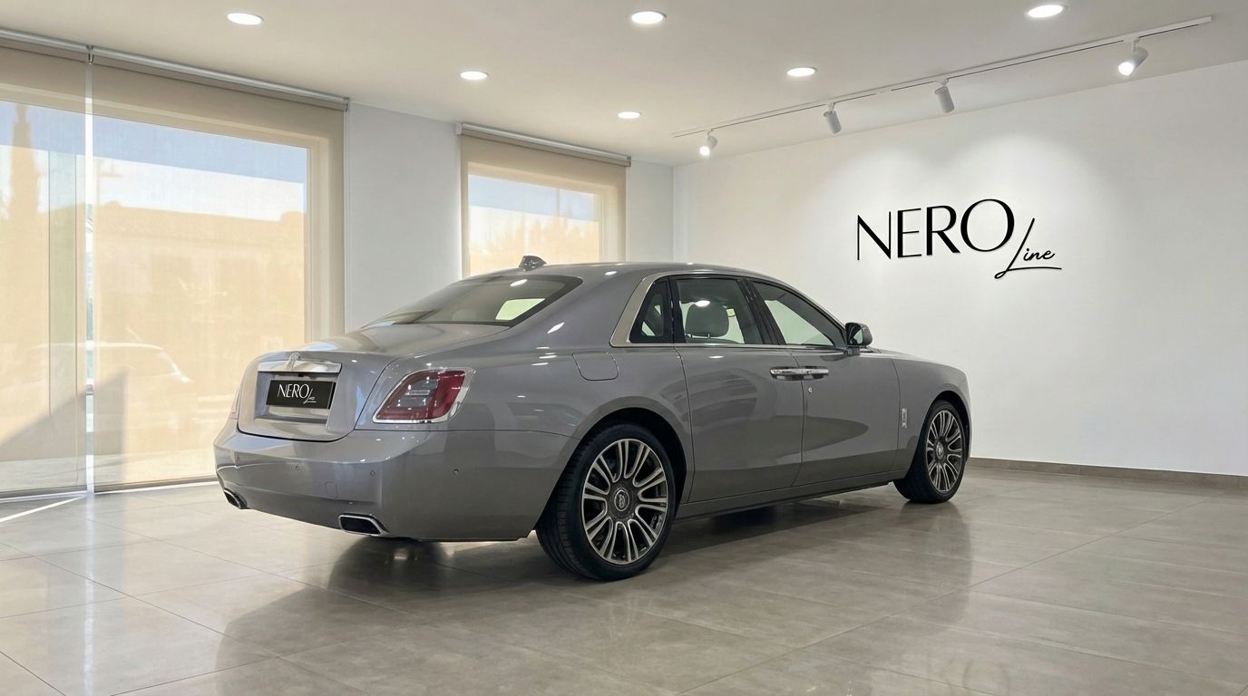 La berline de luxe Rolls-Royce Ghost 2024 gris métallisé est vue de trois quarts arrière dans un showroom à Madrid.