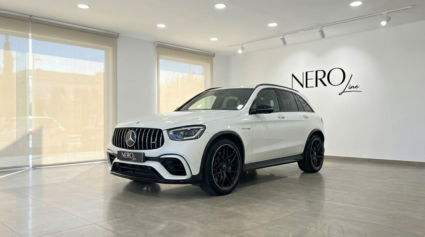 Mercedes-Benz GLC 63 S AMG — Front view Marbella The white 2022 Mercedes-Benz GLC 63 S AMG performance SUV is showcased from a front three-quarter view in a Marbella showroom.