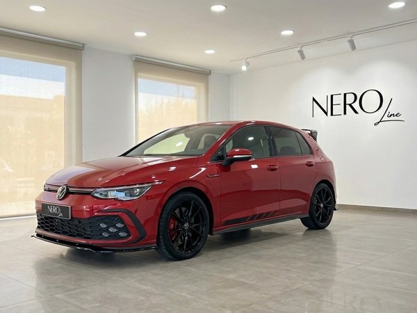 Volkswagen Golf GTI Clubsport — Showroom Alicante The gloss Kings Red Metallic 2024 Volkswagen Golf GTI Clubsport is displayed from a front three-quarter view in a showroom in Alicante.