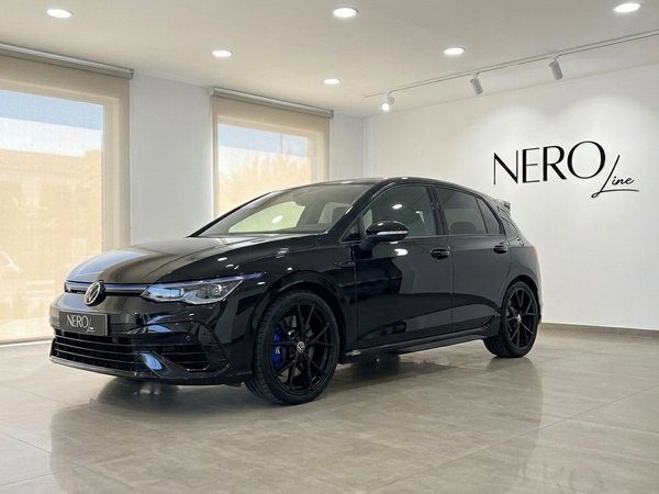 Volkswagen Golf R — Showroom display in Alicante The black 2023 Volkswagen Golf R 2.0 TSI 4Motion DSG is showcased in a modern showroom in Alicante, Spain.