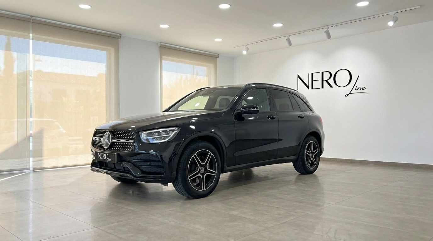 The black metallic Mercedes-Benz GLC 300 AMG Line SUV displayed from a front three-quarter angle in a showroom in Alicante.