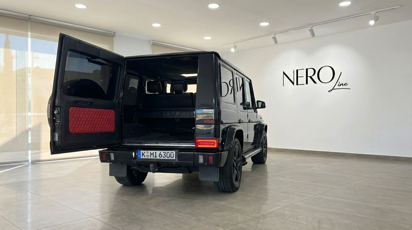 Black Brabus G800 Rocket G-Class SUV from the rear with its trunk open, revealing a red diamond-quilted interior panel in Alicante.