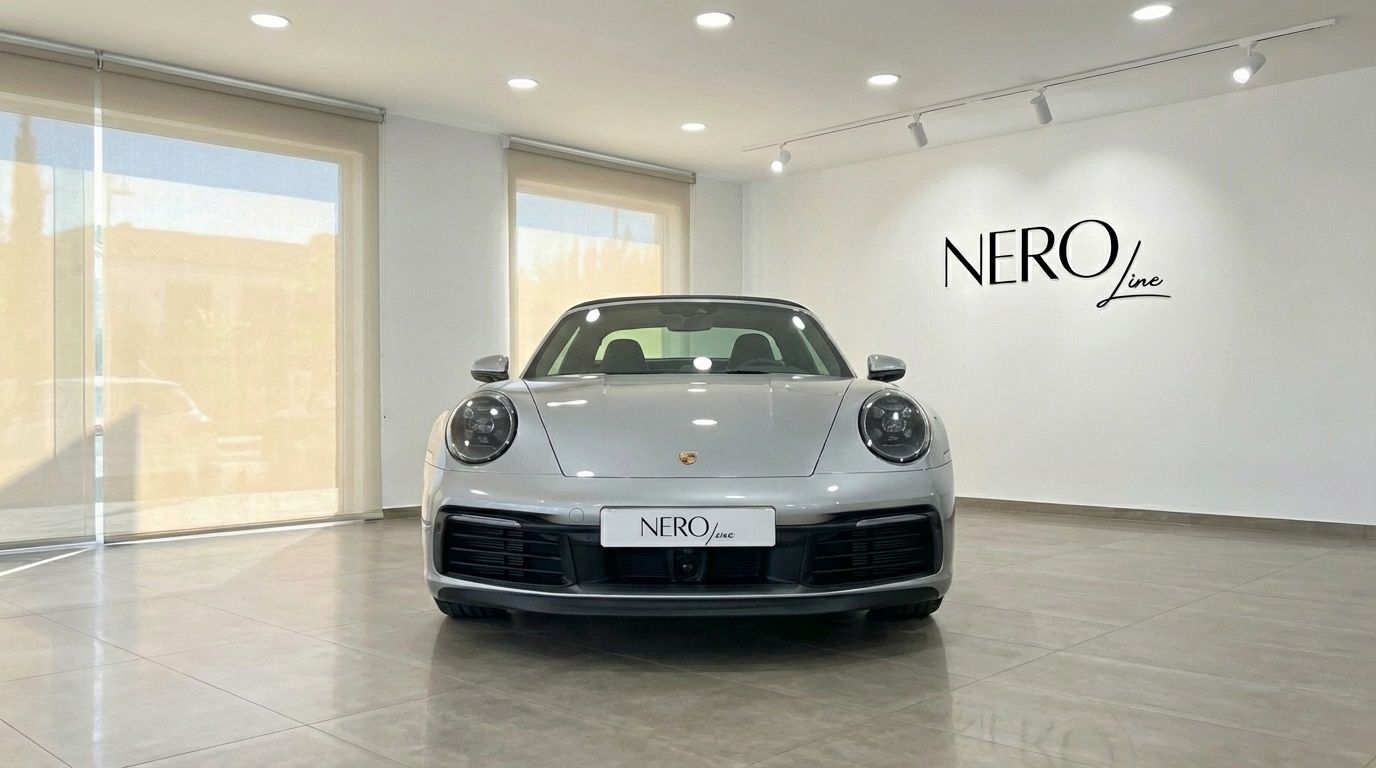 A metallic silver Porsche 911 Carrera 4S Targa 992 is parked frontally in a showroom in Marbella.