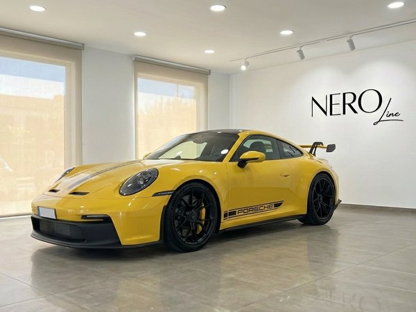 Porsche 911 GT3 992 — Showroom view Alicante A vibrant yellow Porsche 911 GT3 992 is displayed from a front three-quarter angle in a modern Alicante showroom.