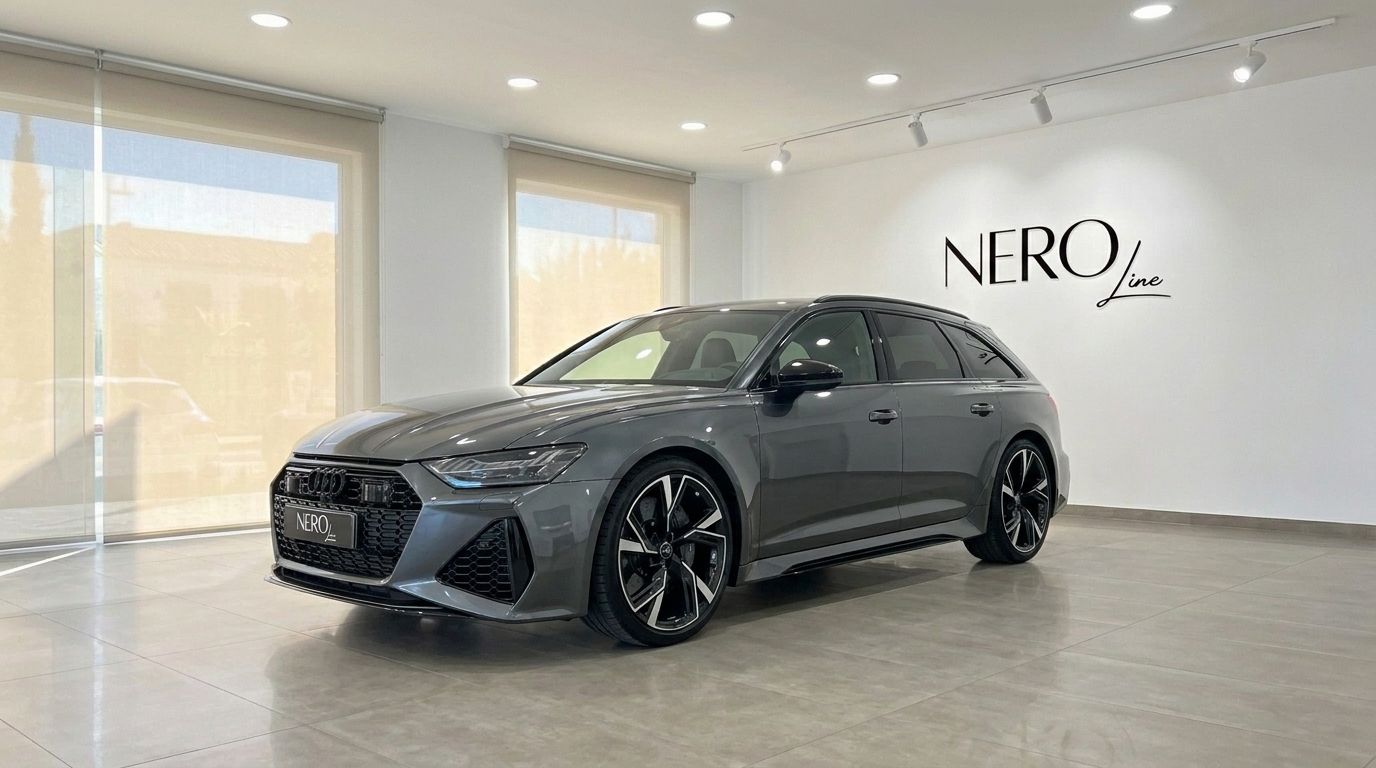 The 2022 Audi RS6 in gloss metallic Daytona Grey Metallic, displayed in a front three-quarter view, parked in a Marbella showroom.
