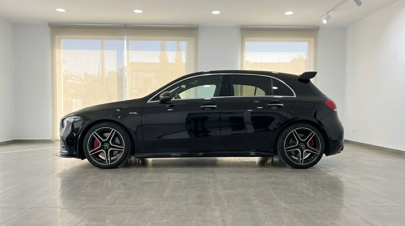 The sleek gloss black Mercedes-Benz A 35 AMG is shown in a side profile view inside a showroom in Alicante.