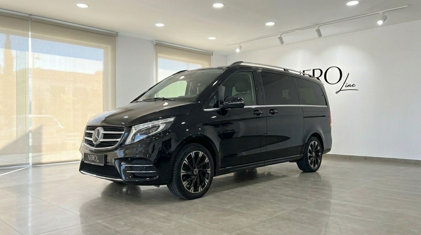The black Mercedes-Benz V-Class luxury van is parked indoors, showcasing its front three-quarter view in Marbella.