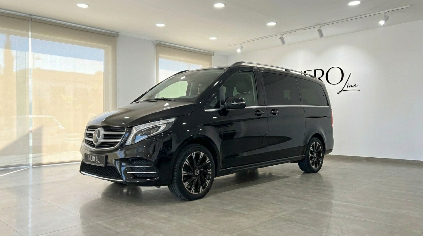 Mercedes-Benz V-Class — Luxury Van Rental The black Mercedes-Benz V-Class luxury van is parked indoors, showcasing its front three-quarter view in Marbella.