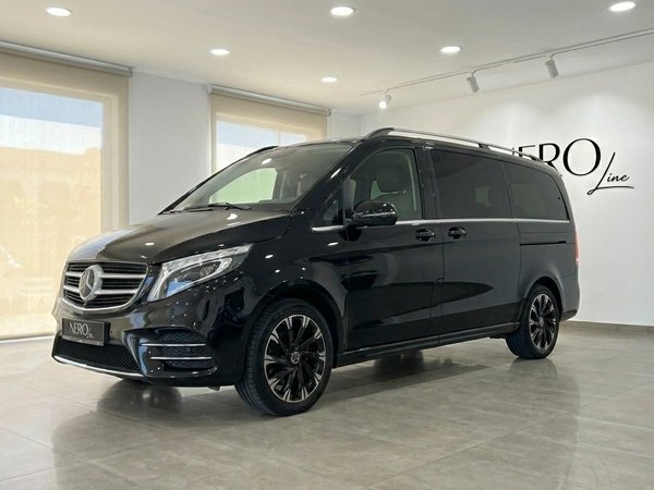 Mercedes-Benz V-Class — Luxury Van Rental The black Mercedes-Benz V-Class luxury van is parked indoors, showcasing its front three-quarter view in Marbella.