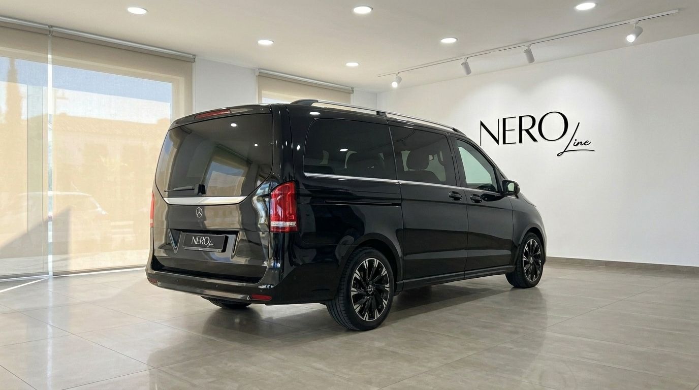 The sleek gloss Obsidian Black Mercedes-Benz V-Class is shown from a rear three-quarter view in a Marbella showroom.