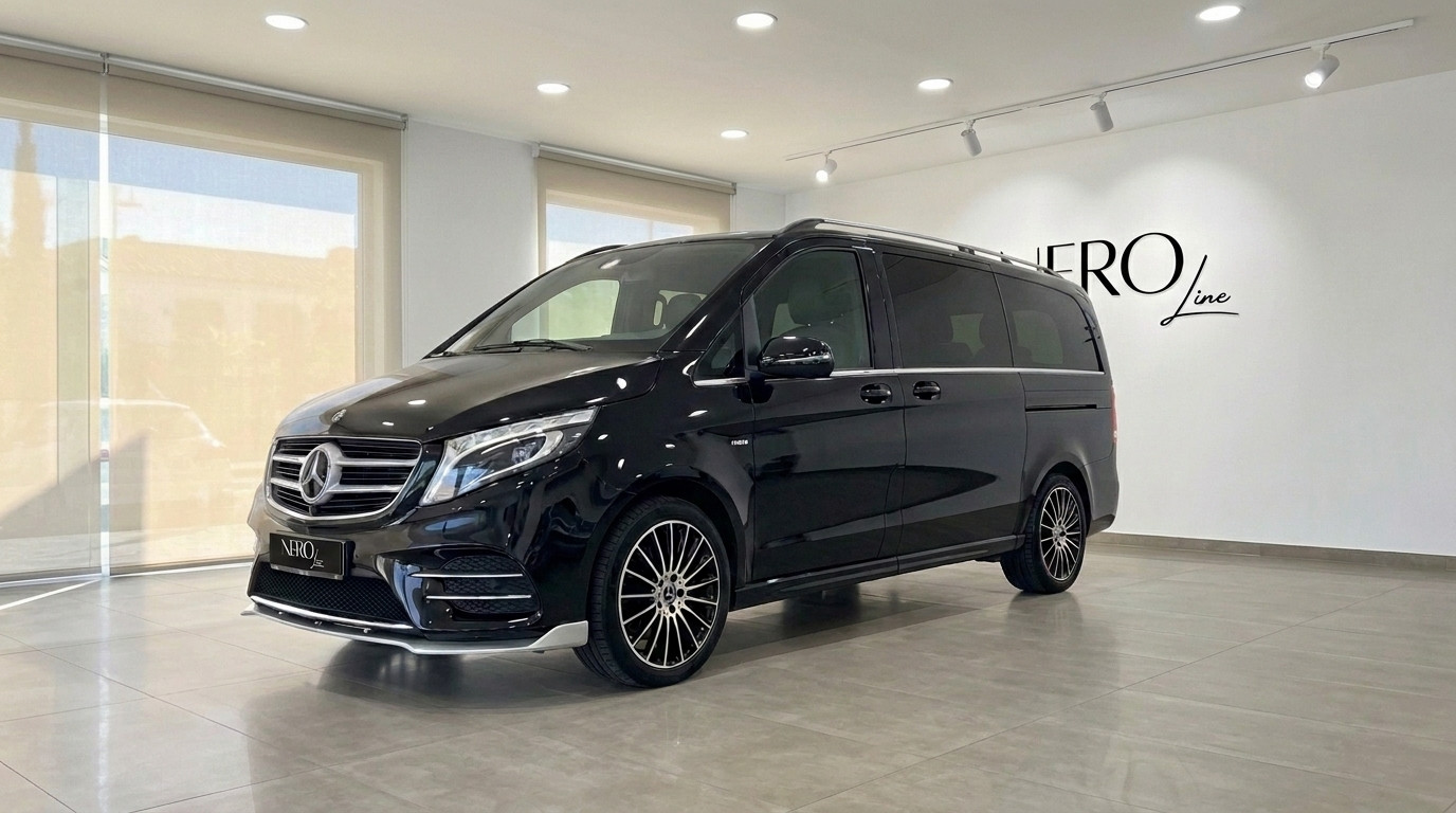Mercedes-Benz V250d Hermes VIP — Showroom view The gloss Obsidian Black Mercedes-Benz V250d Hermes VIP van is showcased from the front three-quarter angle in a Barcelona showroom.