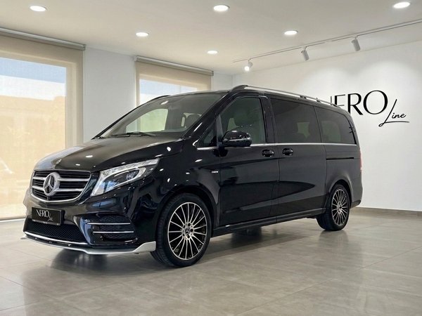 Mercedes-Benz V250d Hermes VIP — Showroom view The gloss Obsidian Black Mercedes-Benz V250d Hermes VIP van is showcased from the front three-quarter angle in a Barcelona showroom.