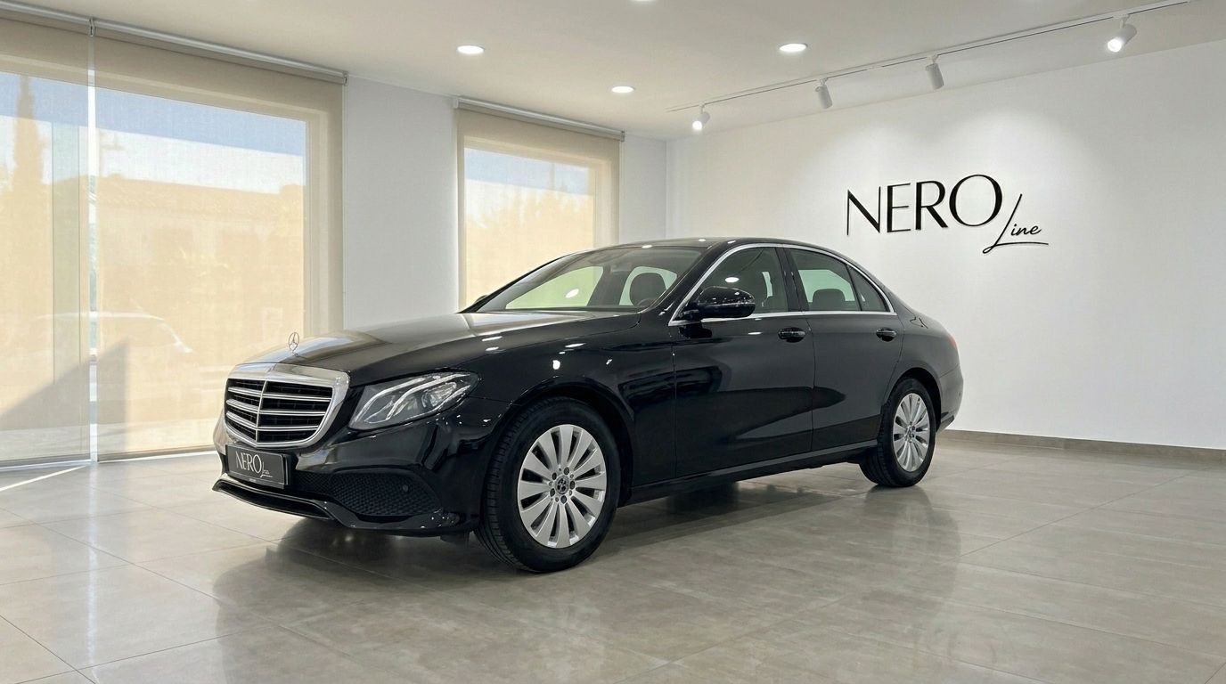 A sleek black 2019 Mercedes-Benz E-Class sedan is showcased from a front three-quarter view in a bright Alicante showroom.