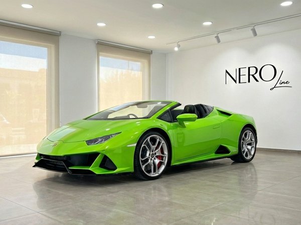 Lamborghini Huracan Evo Spyder — Marbella showroom Lime green Lamborghini Huracan Evo Spyder convertible showcased from a front-side angle in a bright Marbella showroom.