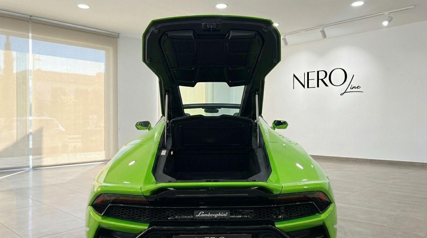Lime green Lamborghini Huracan Evo Spyder, rear view with open trunk, showcasing storage in a Marbella showroom.