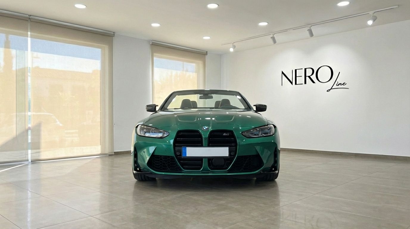 A striking emerald green BMW M4 Competition Convertible is parked head-on in a showroom in Alicante, showcasing its bold front grille.