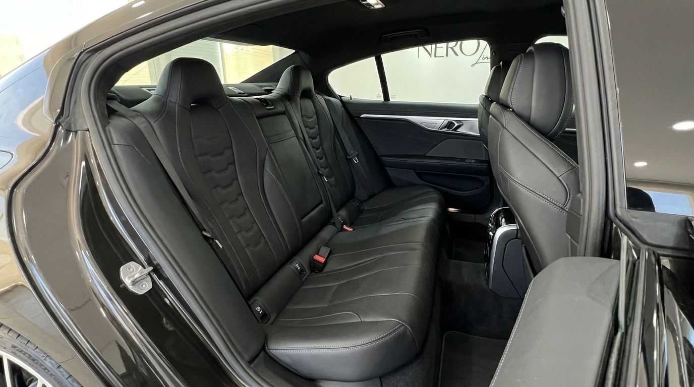 View of the luxurious black leather rear seats and spacious interior of the BMW M850i Grandcoupe in Barcelona.
