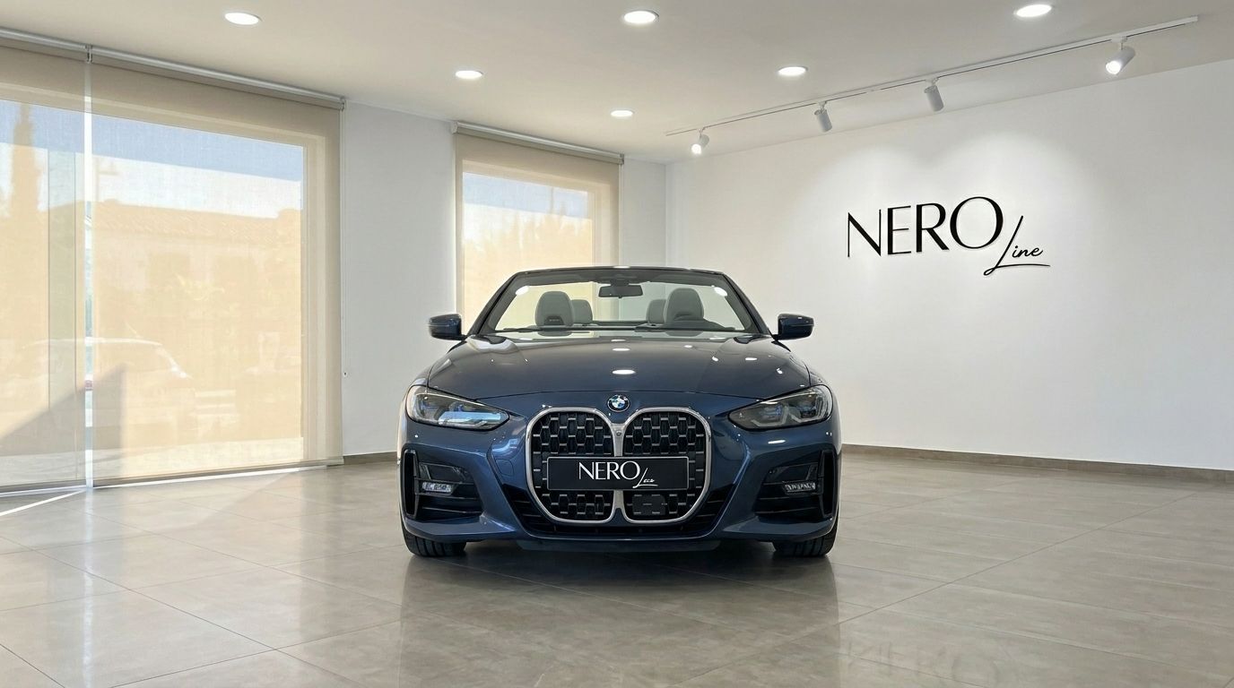 The 2022 BMW 420 Cabriolet is showcased from the front with its convertible top down in a modern showroom in Alicante.