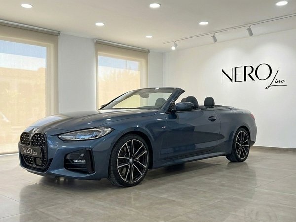 BMW 420 Cabriolet — Luxury convertible in Alicante The dark blue BMW 420 Cabriolet is displayed with its top down, showcasing its sleek design in a showroom in Alicante.