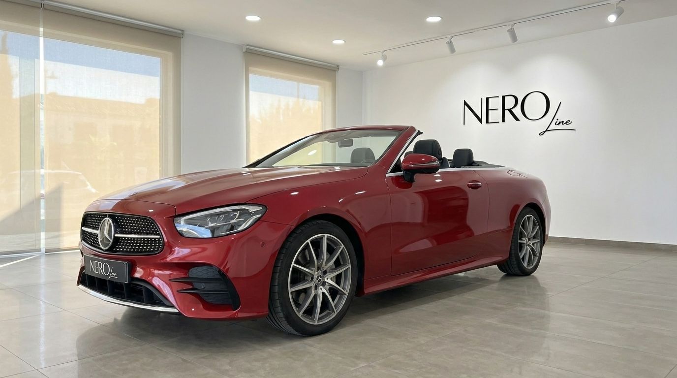 Red Mercedes-Benz E300 Cabrio convertible, seen from the front three-quarter angle, parked in a showroom in Alicante.