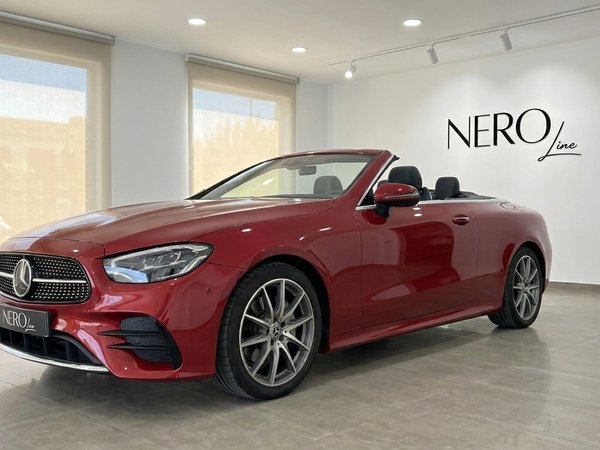 Mercedes-Benz E300 Cabrio — Luxury convertible in Alicante Red Mercedes-Benz E300 Cabrio convertible, seen from the front three-quarter angle, parked in a showroom in Alicante.