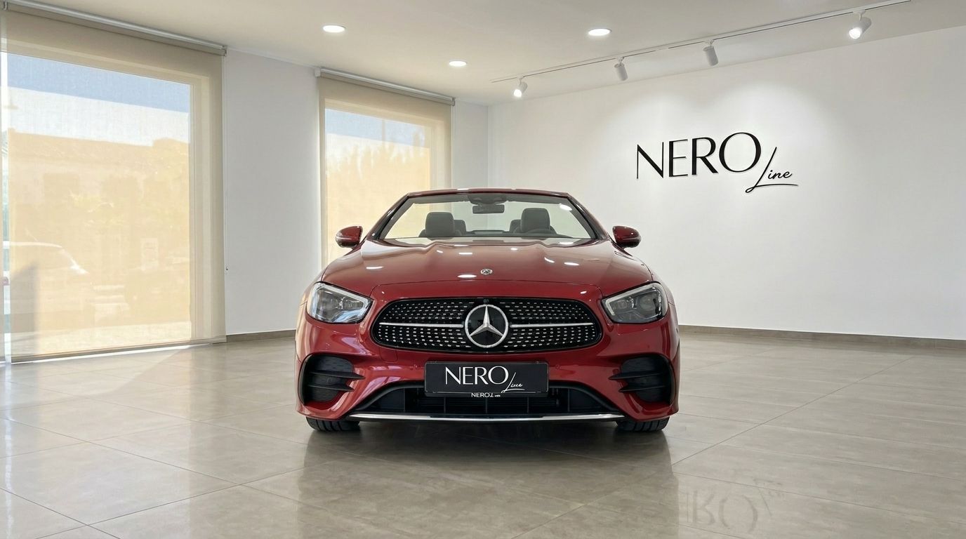 Red Mercedes-Benz E300 Cabrio convertible with its top down, parked frontally in a bright showroom in Alicante.