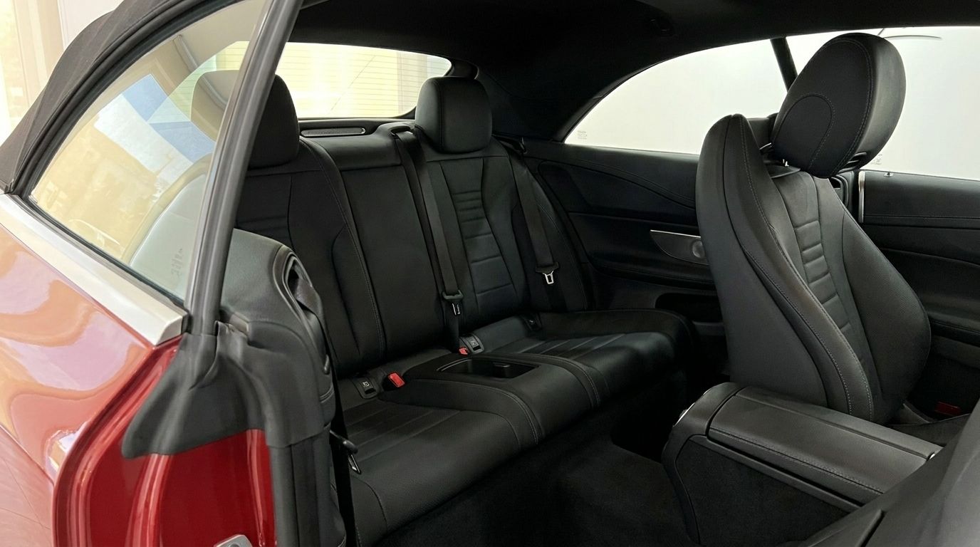 View of the luxurious black leather rear seats and front passenger seat inside the Mercedes-Benz E300 Cabrio in Alicante.