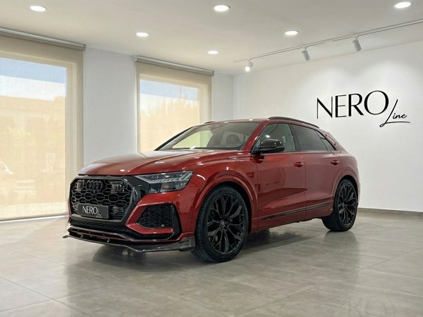 Audi SQ8 — Metallic red performance SUV Audi SQ8 with RSQ8 body kit, a metallic red performance SUV, parked in a showroom in Alicante.