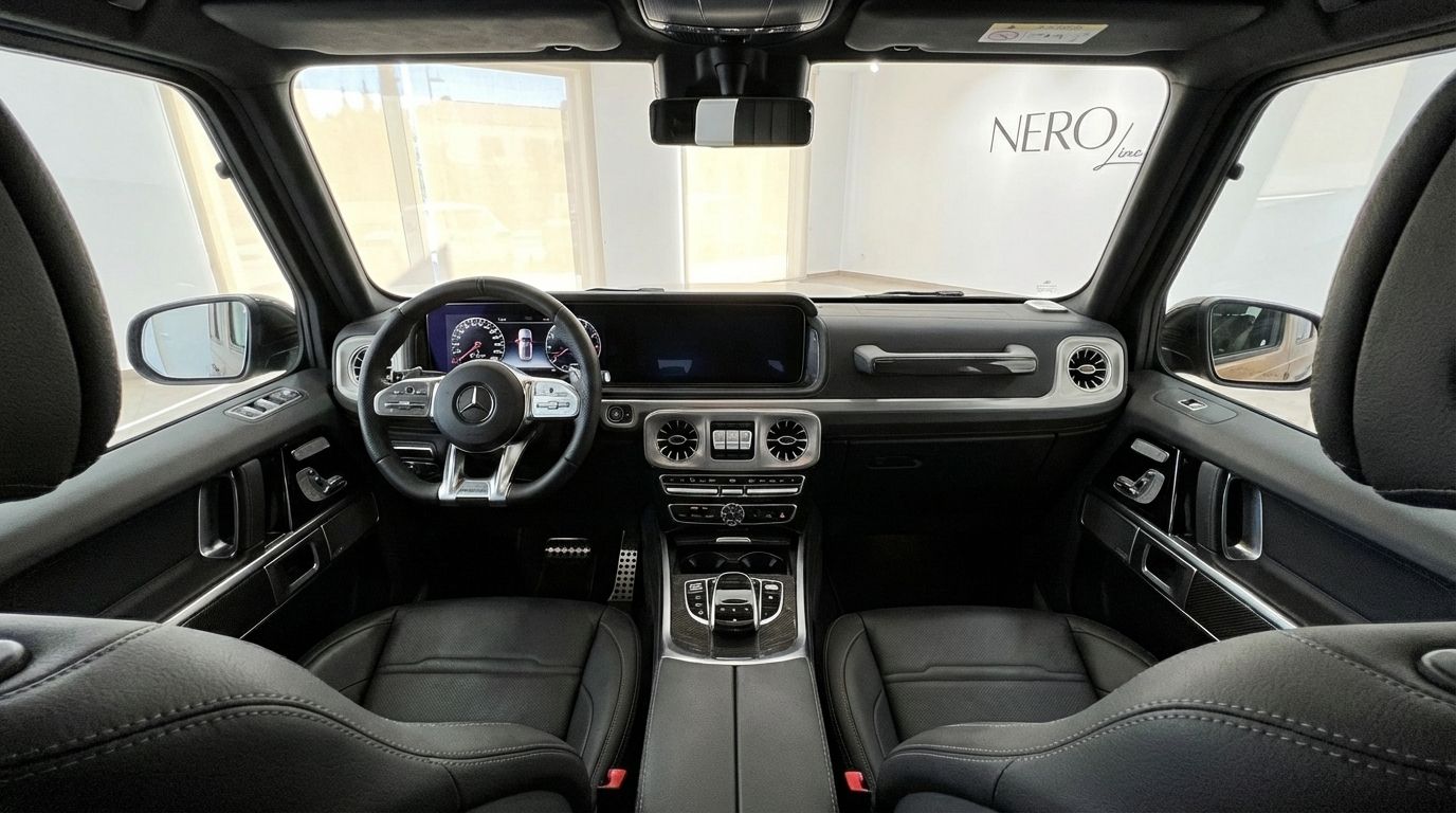 The opulent interior of the Mercedes-Benz AMG G 63 in Alicante, showcasing its advanced dashboard and plush black leather seats.